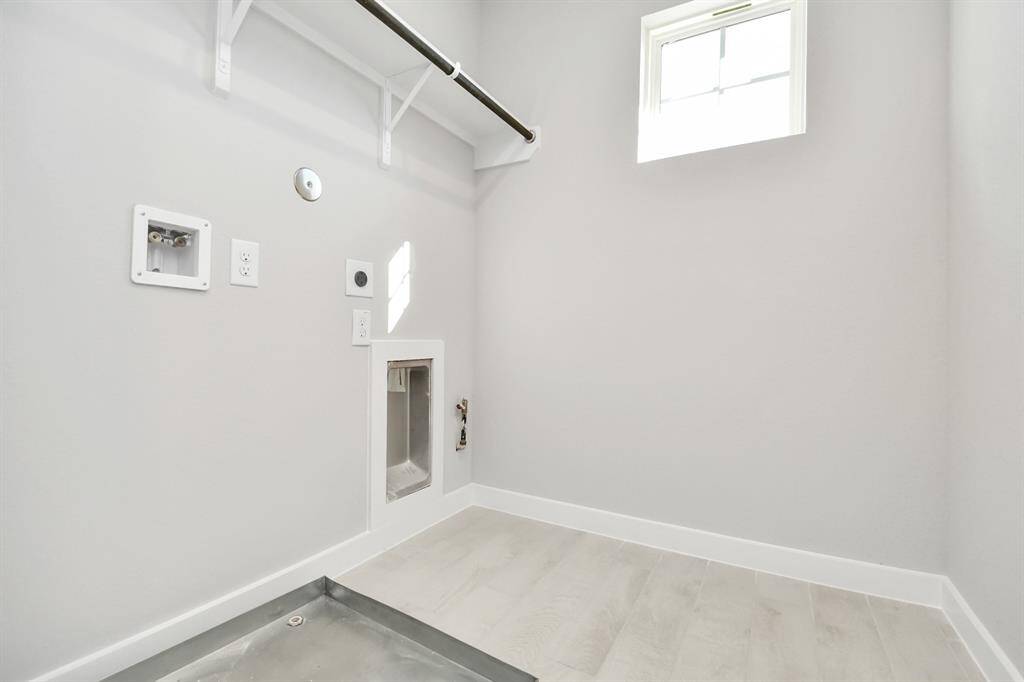 A perfect blend of functionality and comfort. Capture the essence of easy living with a first-floor laundry room, thoughtfully equipped with shelving for effortless organization. Bothelectric and gas connections available.