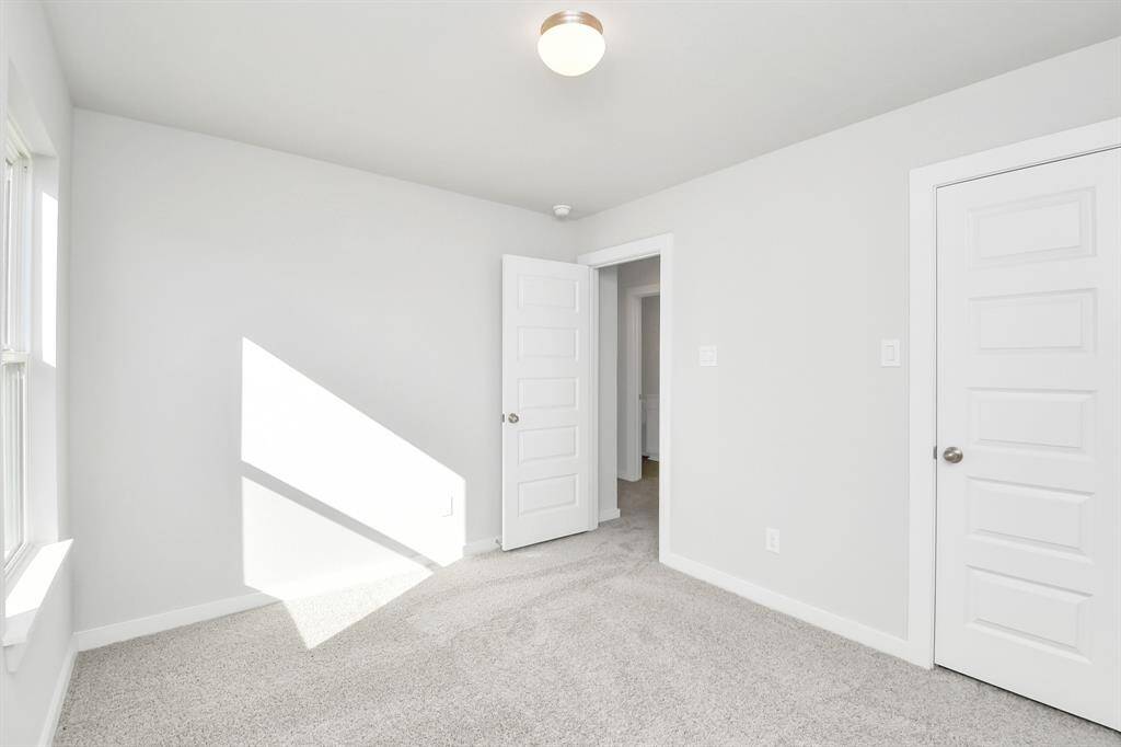 Generously sized secondary bedrooms featuring spacious closets, soft and inviting carpetingunderfoot, large windows allowing plenty of natural light, and the added touch of privacyblinds for your personal retreat.