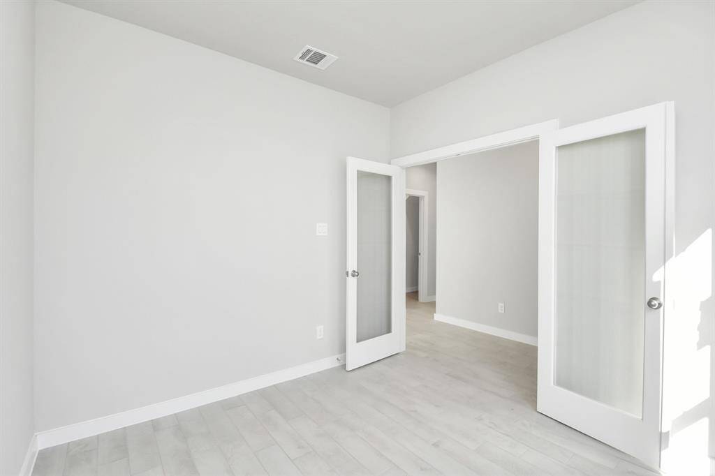 Quietly nestled in front of the home is the sophisticated home office. Featuring elegant flooring, custom paint and large windows.