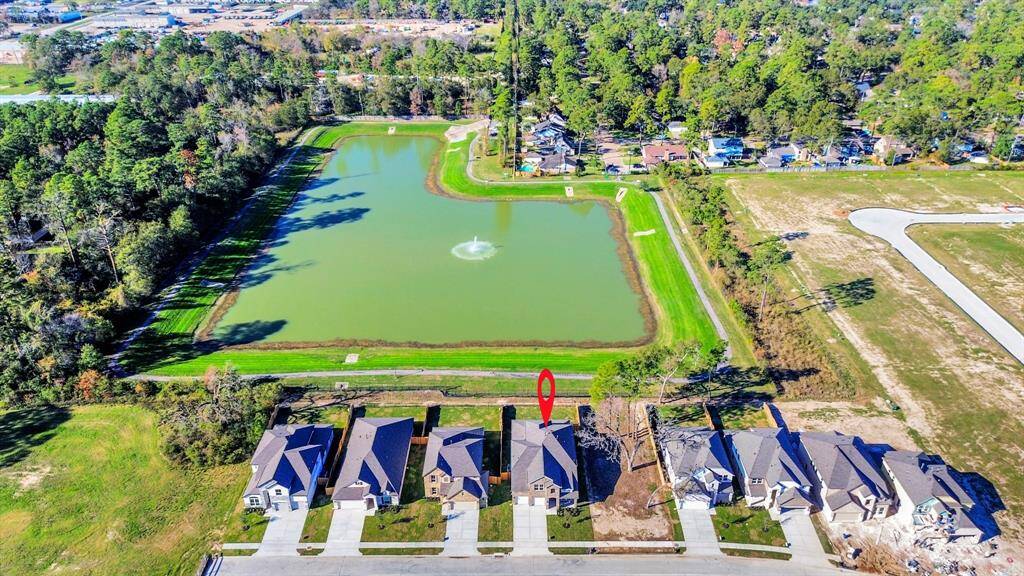An aerial view of a spacious subdivision lot, highlighting a well-maintained yard and a fully fenced perimeter, offering both privacy andexpansive outdoor space.