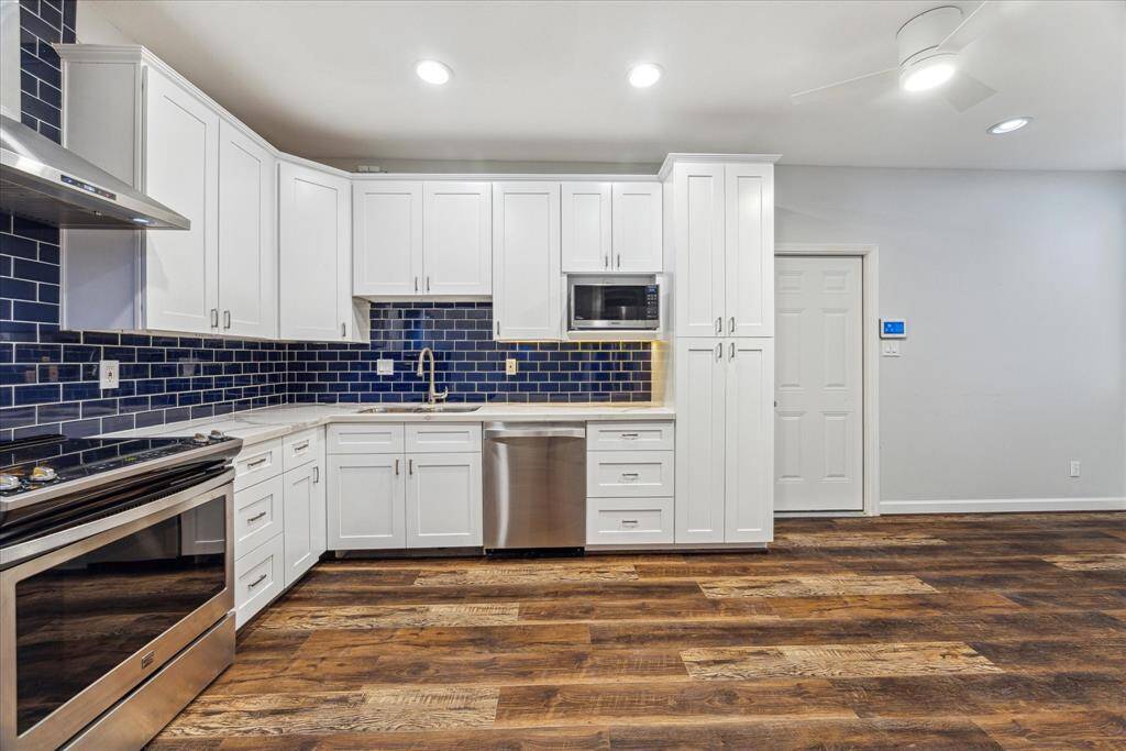 The Kitchen pops with the cool, crisp blue subway tile backsplash!  Stainless steel appliances complete the space.