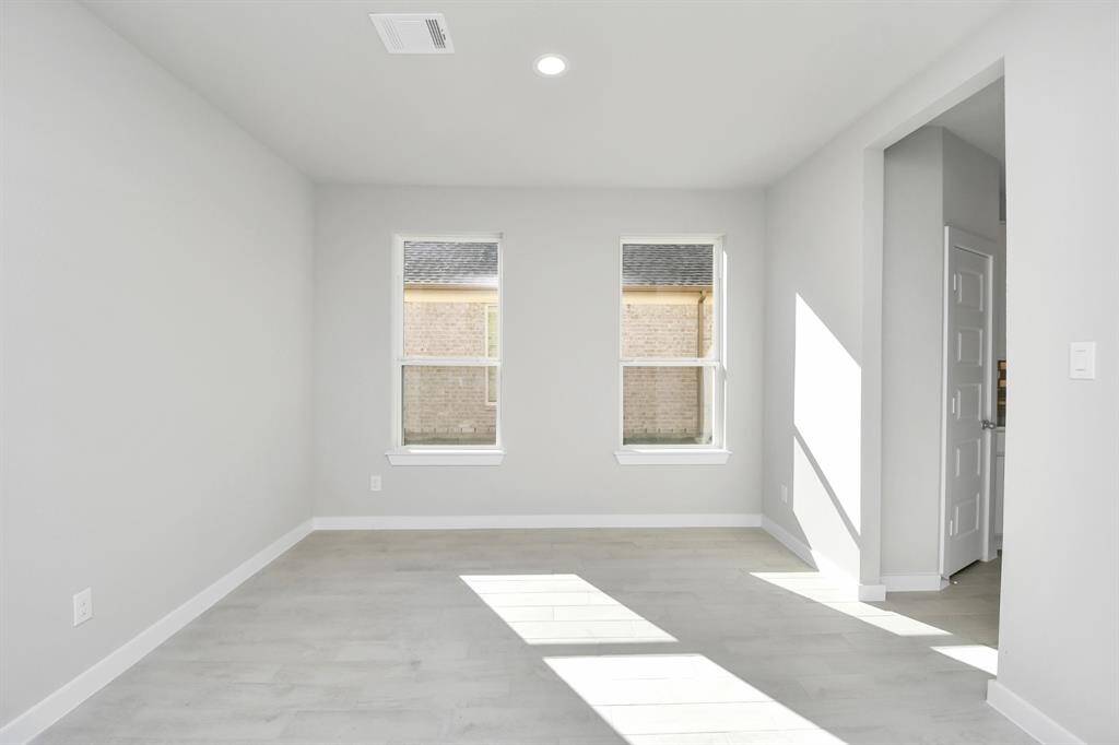 Make memories gathered around the table with your family and friends! This spacious diningroom features elegant flooring, custom paint, and adjacent to family room and kitchen foropen concept feel.