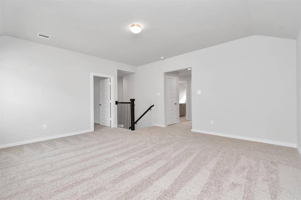 Ascend to relaxation in this fantastic game room! Ideal for both casual gatherings and adult gaming, it boasts plush carpet, lofty ceilings, custom paint, and ample windows for abundant natural light. Sample photo of completed home with similar floor plan. As-built interior colors and selections may vary.