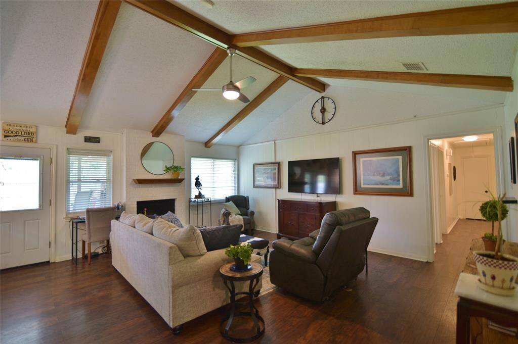 Plenty of room for a table behind the couch, and various accent pieces for a grouping around the fireplace or the TV watching area....door leads to the covered patio and large back yard area...right hand door leads to the bedroom wing....