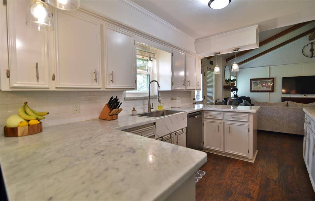 View from the kitchen back into the family room....crown molding finishes off the designer touches in this charming kitchen!