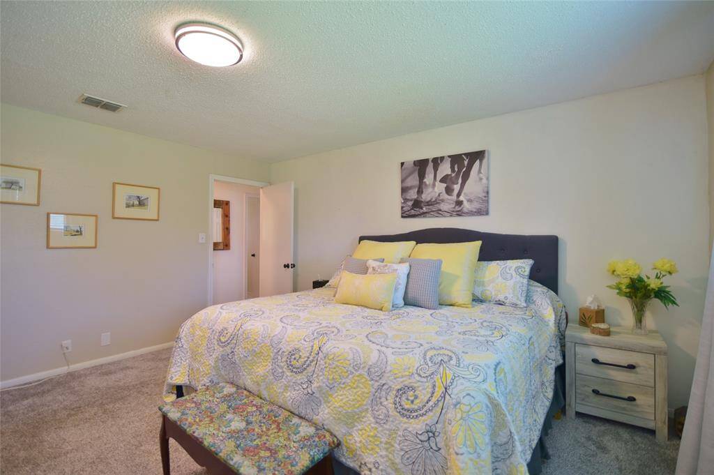 An alternative view of the primary bedroom with the door leading to the hallway....