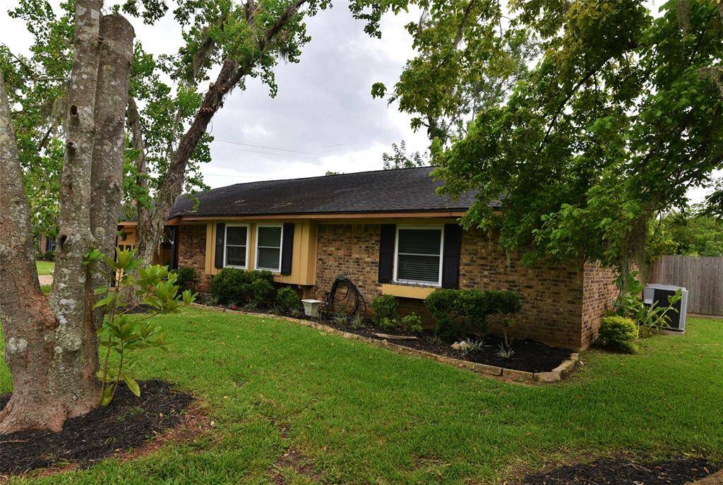 Brick down the sides and back of the ranch style house, with attached garage and double driveway....