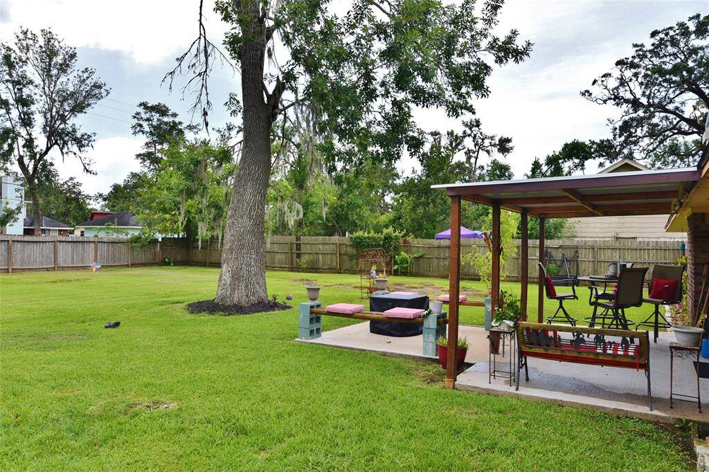 Spacious yard, mature tree for shade, covered and extended patio for a great entertaining spot!