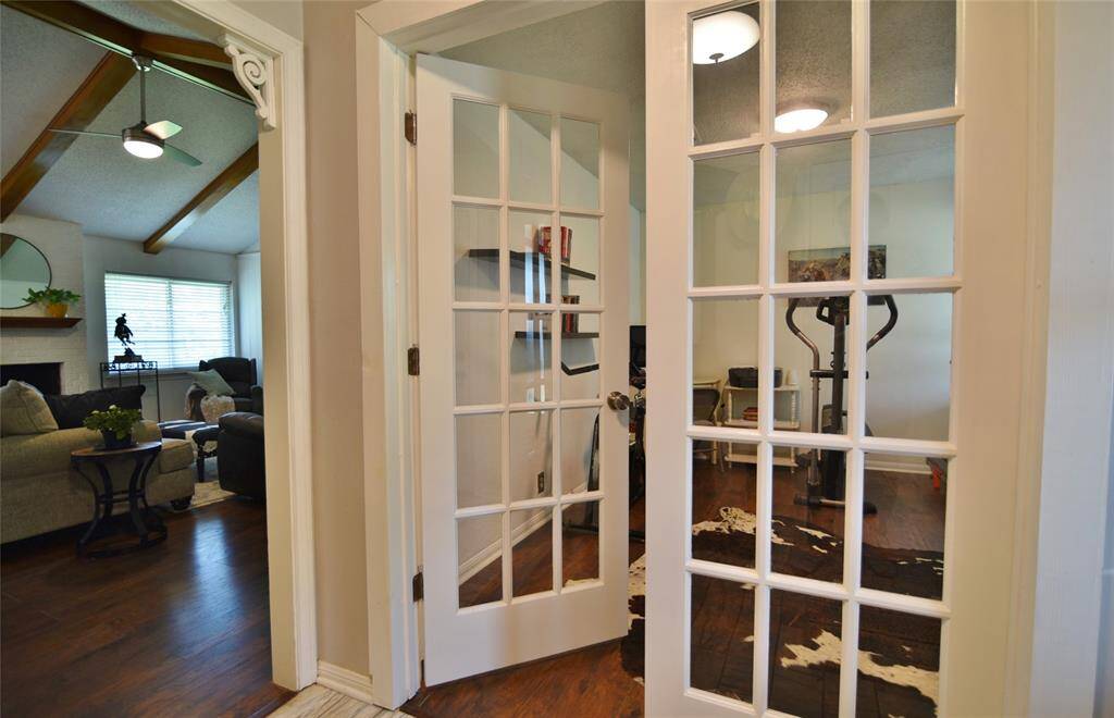 Home office with French doors sits just inside the front door....