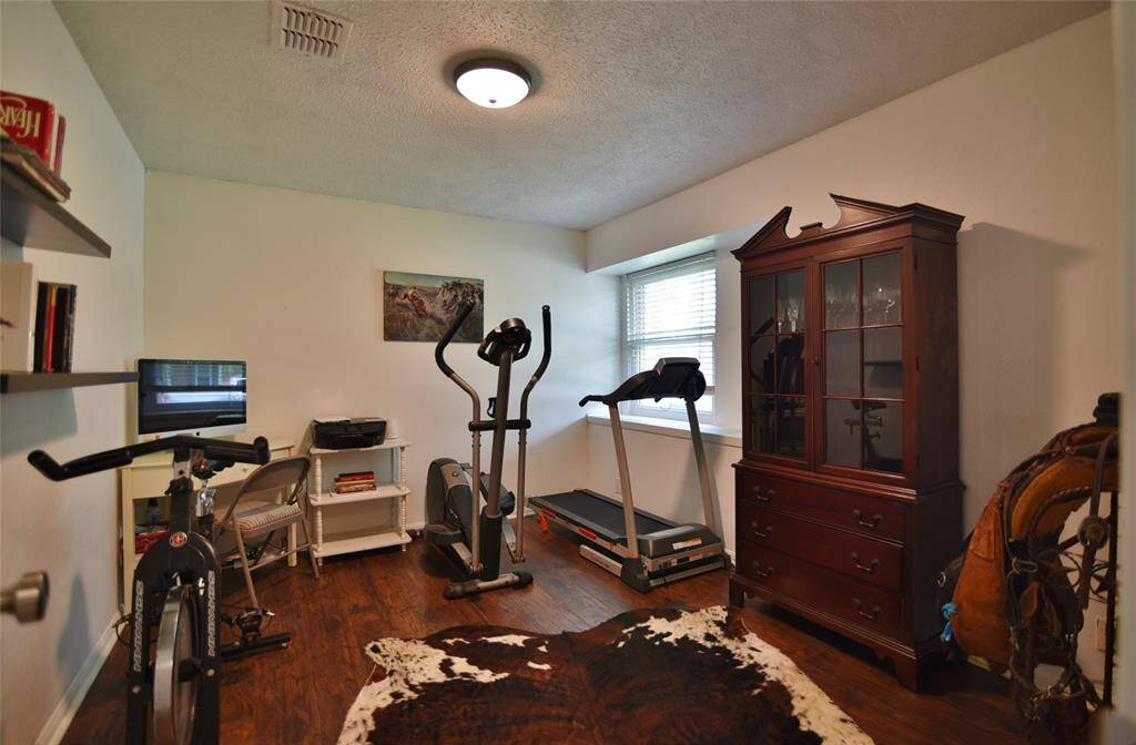 Wide window ledge with a view of the front yard inside your office, formal dining room, or workout room!