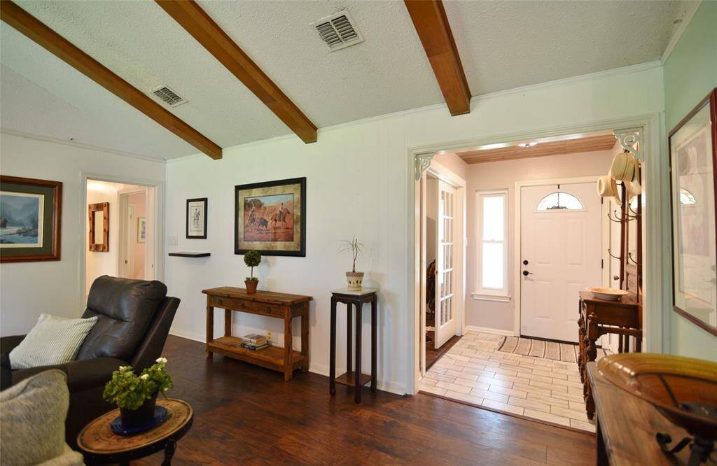 A view back into the foyer with its tiled floors, dramatic ceiling, and corbel accents....