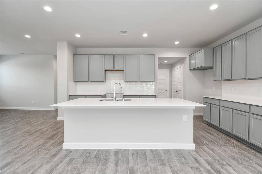 Create lasting memories with your family and friends at the dining table! This expansive dining room showcases sophisticated flooring, custom paint, and seamlessly connects to the family room and kitchen, providing an open and inviting atmosphere!