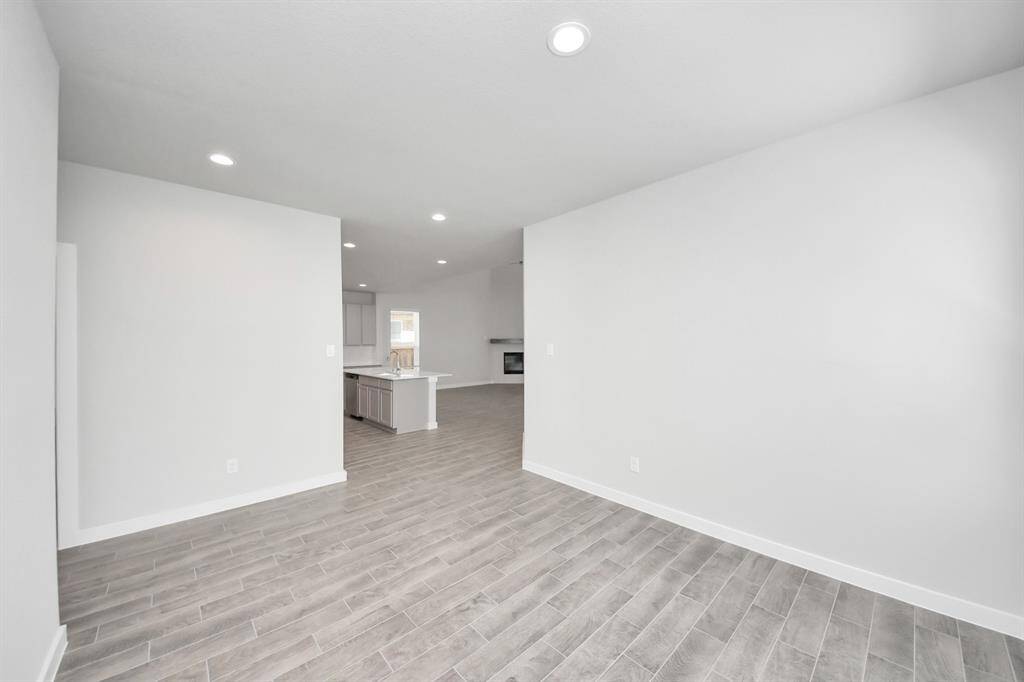 Craft enduring memories with loved ones around the table! This roomy dining area boasts stylish flooring, personalized paint, and is conveniently situated next to the family room and kitchen.