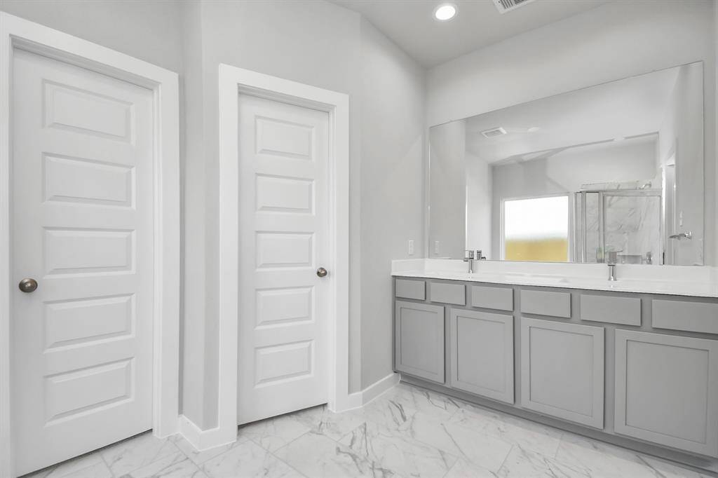Family room flooded with natural light through the expansive windows.  The premium tile flooring adds a touch of luxury to the space, creating the perfect setting for relaxing moments and cherished gatherings with loved ones