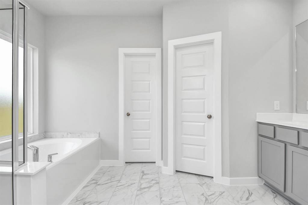 Come and unwind after a long day in this magnificent primary suite! This spacious room features plush carpet, warm paint, high ceilings and large windows with privacy blinds.