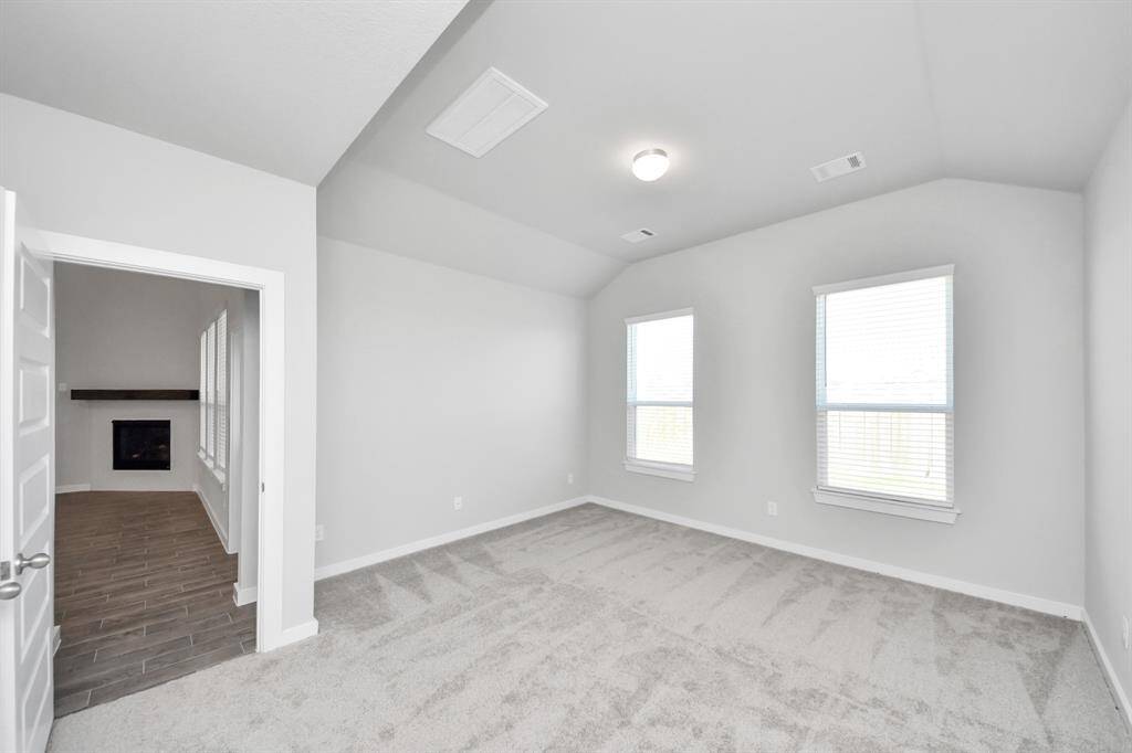 Another perspective unveils a comprehensive view of the serenity and comfort this primary suite offers.