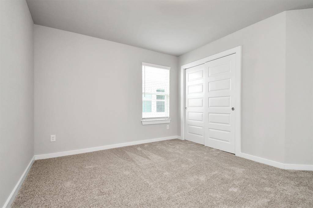 Indulge in a spa-like retreat within the confines of this primary bathroom. Delight in a spacious walk-in shower enveloped in stylish tile surround and unwind in a separate garden tub adorned with custom detailing.