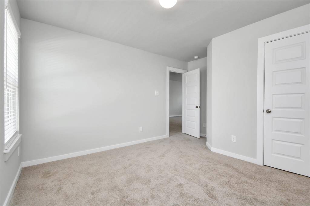 Generously sized secondary bedrooms featuring spacious closets, soft and inviting carpeting underfoot, large windows allowing plenty of natural light, and the added touch of privacy blinds for your personal retreat.
