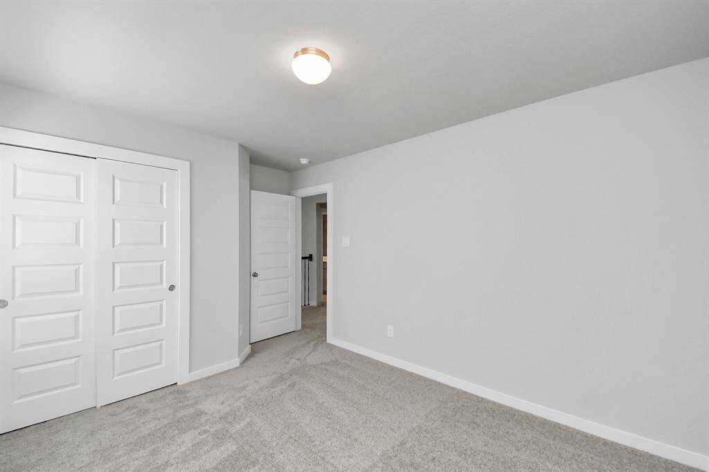 Generously sized secondary bedrooms featuring spacious closets, soft and inviting carpeting underfoot, large windows allowing plenty of natural light, and the added touch of privacy blinds for your personal retreat.