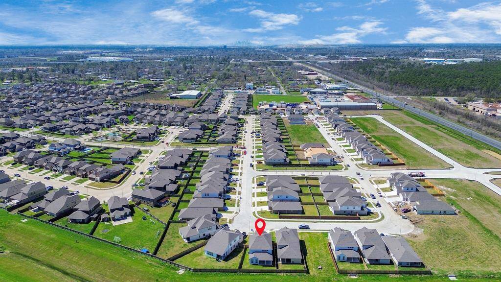 An aerial view of a spacious subdivision lot, highlighting a well-maintained yard and a fully fenced perimeter, offering both privacy and expansive outdoor space.