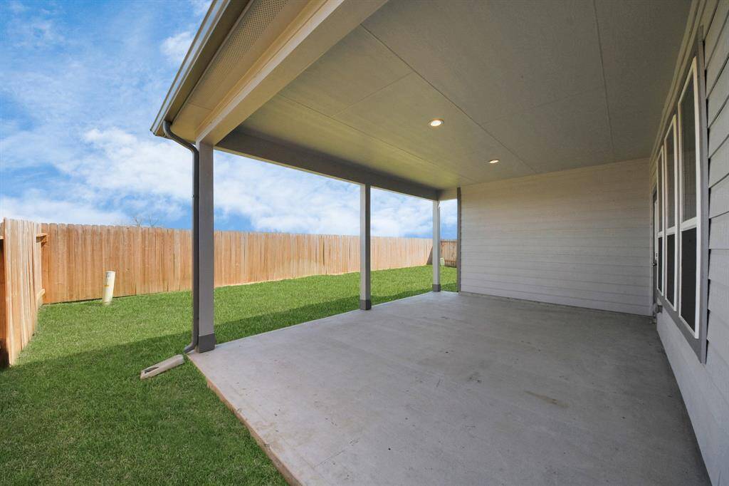 Experience outdoor living at its finest on this expansive covered patio, thoughtfully designed for BBQs and delightful outdoor dining