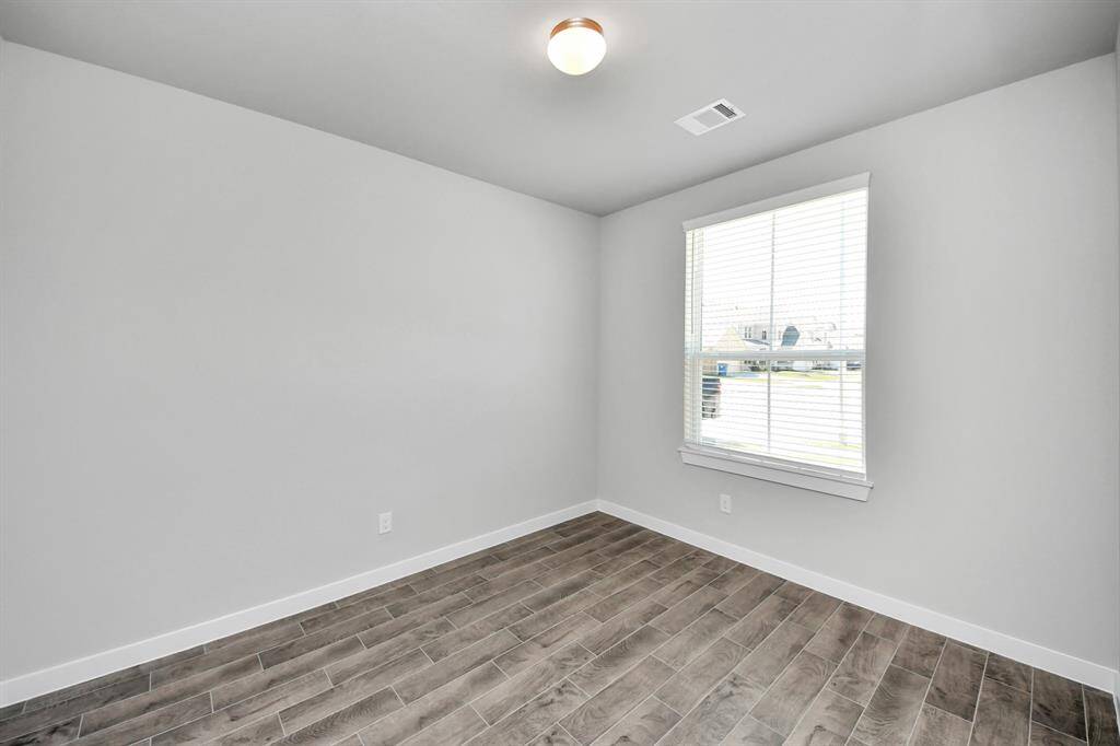 Step into the inviting home office, where elegant tile flooring adds a touch of freshness and comfort to the workspace. Natural light pours through the window, creating an inspiring environment for productivity and focus.
