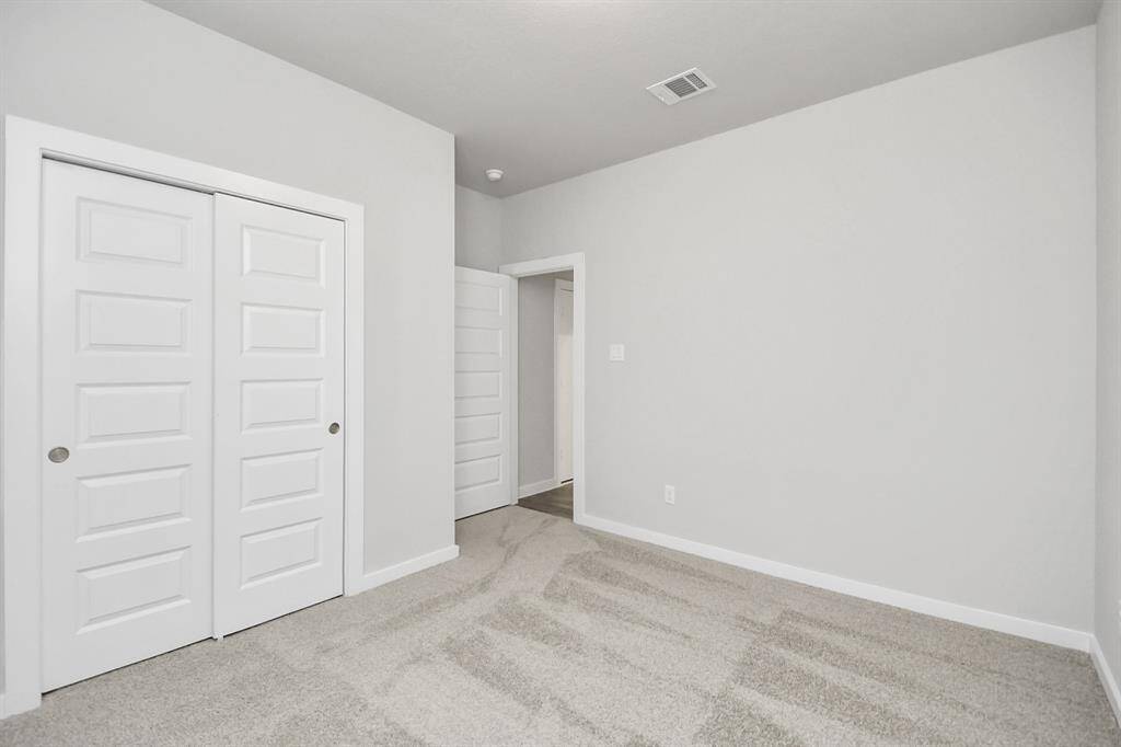 Generously sized secondary bedrooms featuring spacious closets, soft and inviting carpetingunderfoot, large windows allowing plenty of natural light, and the added touch of privacyblinds for your personal retreat.