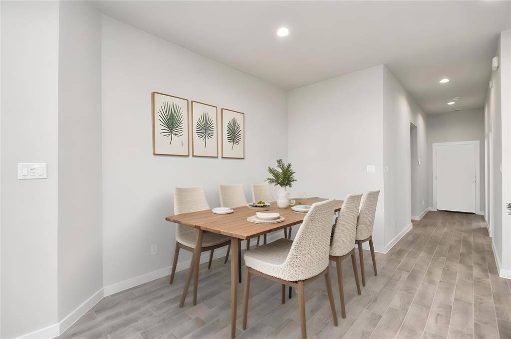 *Virtually Staged* Make memories gathered around the table with your family and friends! This spacious diningroom features elegant flooring, custom paint, and adjacent to family room and kitchen foropen concept feel.