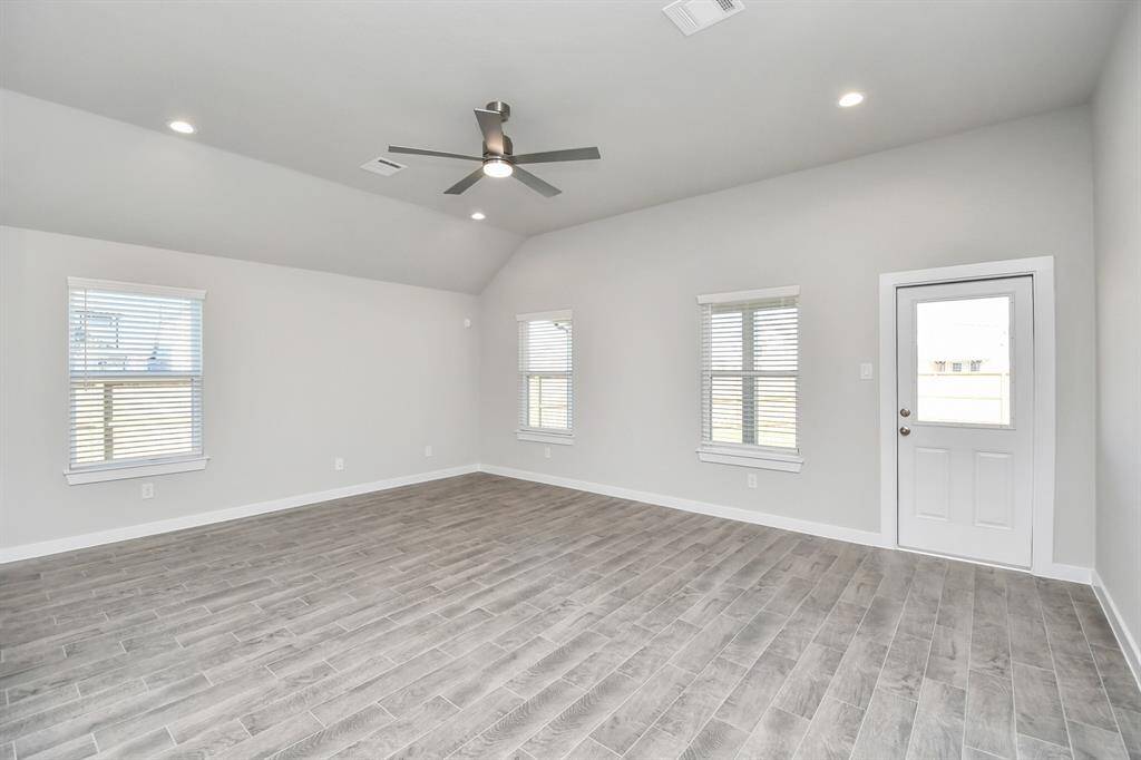 Gather the family and guests together in your lovely living room! Featuring soaring highceilings, recessed lighting, ceiling fan, custom paint, gorgeous floors, and large windows thatprovide plenty of natural lighting throughout the day.