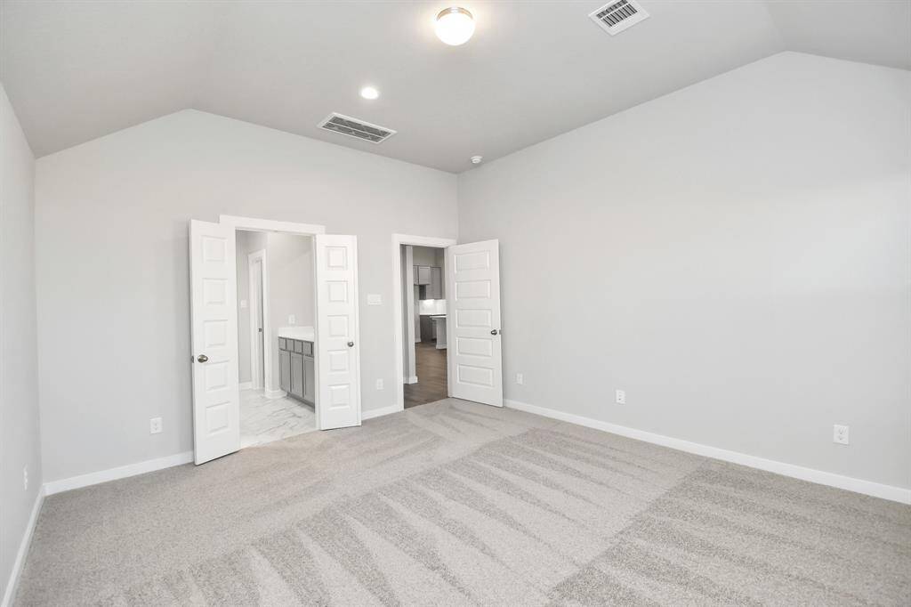 Come and unwind after a long day in this magnificent primary suite! This spacious roomfeatures plush carpet, warm paint, high ceilings and large windows with privacy blinds.