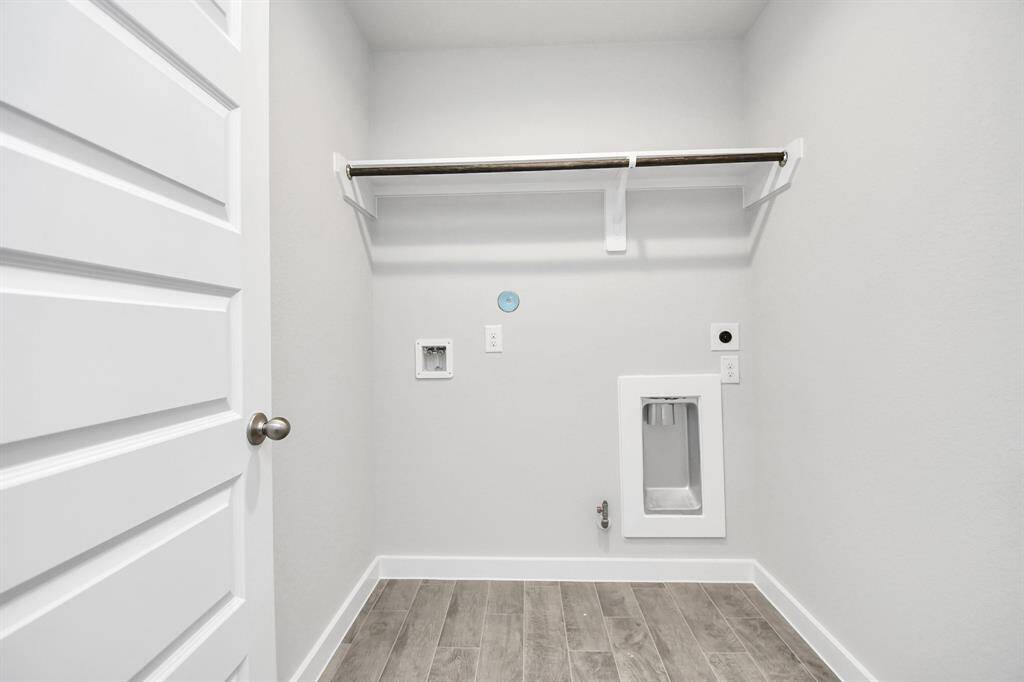A perfect blend of functionality and comfort. Laundry room, thoughtfully equipped with shelving for effortless organization. Both gas and electric dryer connections available.