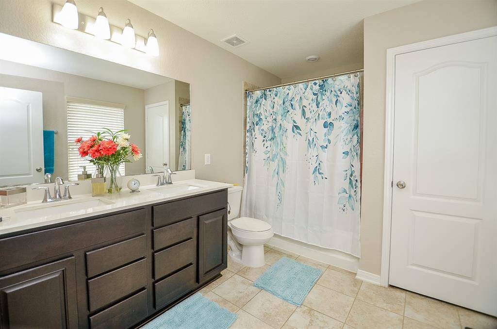 Primary bathroom with lots drawer space, and double sinks