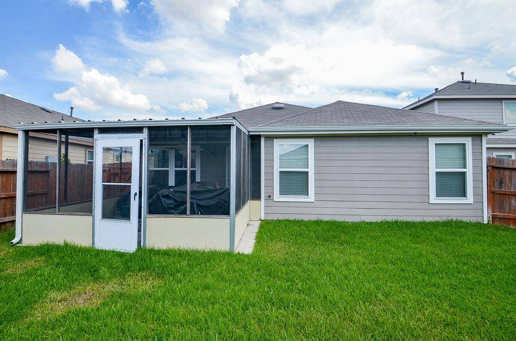 View of back yard with screened in porch.