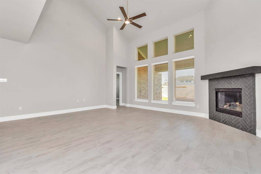 Experience another perspective of the open-concept family room – envision hosting guests in the heart of the home or relishing a cozy movie night in this inviting and relaxing setting.  Sample photo, as built color and selections may vary.