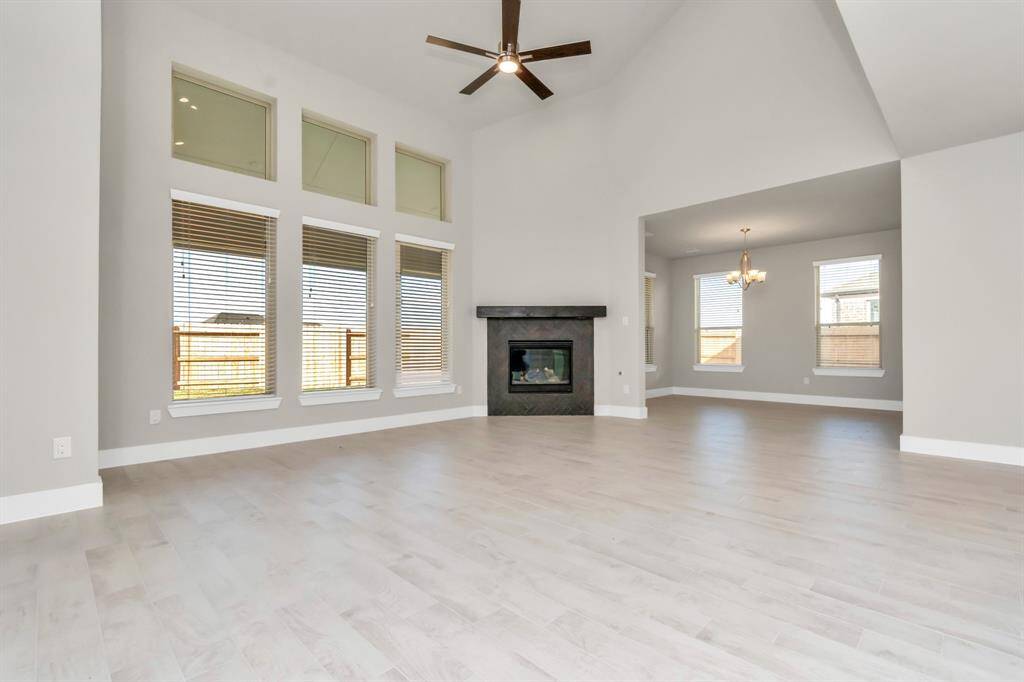 Experience another perspective of the open-concept family room – envision hosting guests in the heart of the home or relishing a cozy movie night in this inviting and relaxing setting.  Sample photo, as built color and selections may vary.