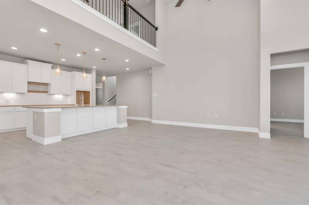 Additional view of the open and bright kitchen met by the family room.  Sample photo, as built color and selections may vary.