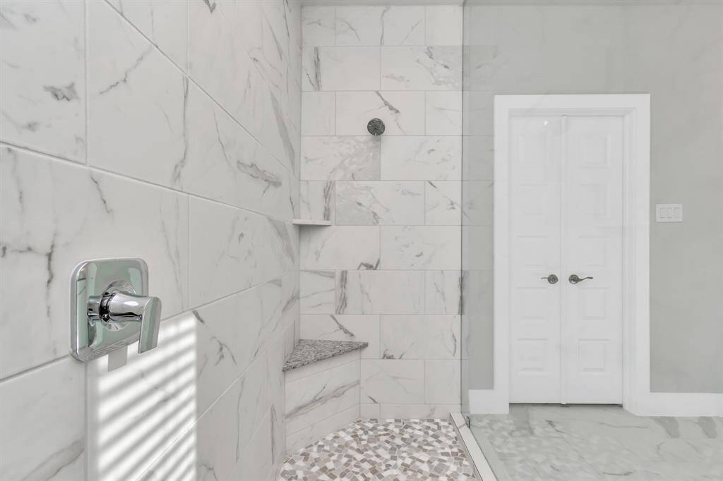 Sleek modern hardware throughout the primary bath.  Sample photo, as built color and selections may vary.