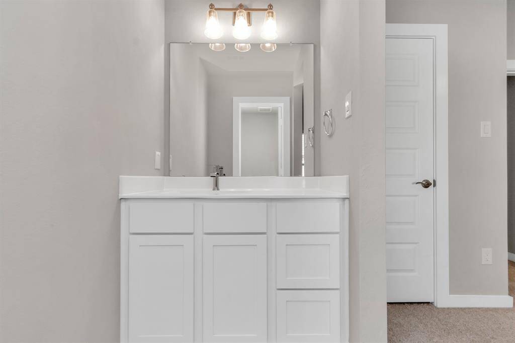 Elevating daily routines with a touch of sophistication – the sleek and functional vanity area in our Jack and Jill bedroom arrangement. Where style meets convenience.  Sample photo, as built color and selections may vary.