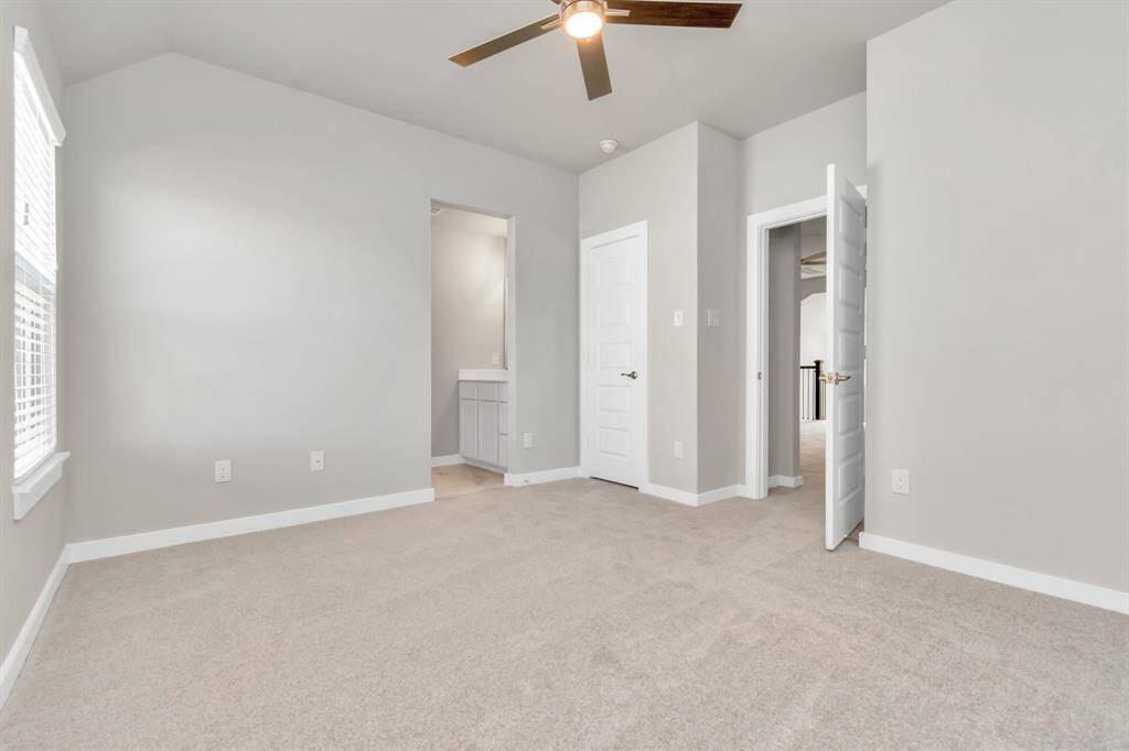 Experience luxury in the generously sized secondary bedrooms, boasting ample closet space, soft and inviting carpeting, large windows welcoming abundant natural light, and the added privacy of blinds for your personal retreat. The indulgence continues with a Jack and Jill bathroom, seamlessly connecting and enhancing the convenience of these  living spaces.  Sample photo, as built color and selections may vary.