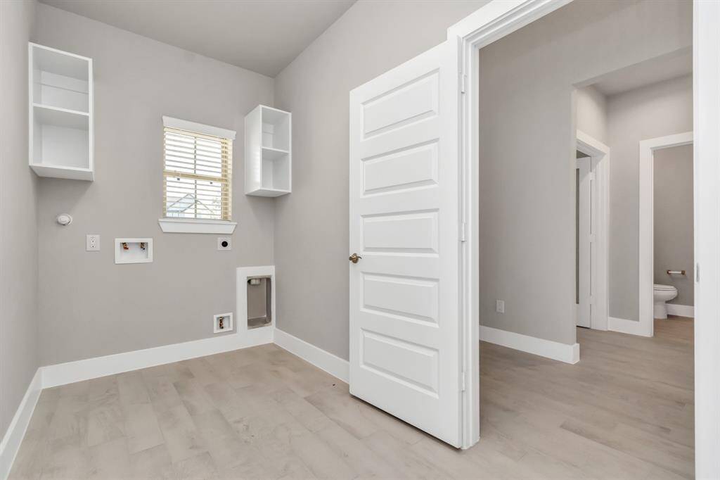 A perfect blend of functionality and comfort. Capture the essence of easy living with a first-floor laundry room, thoughtfully equipped with shelving for effortless organization.
