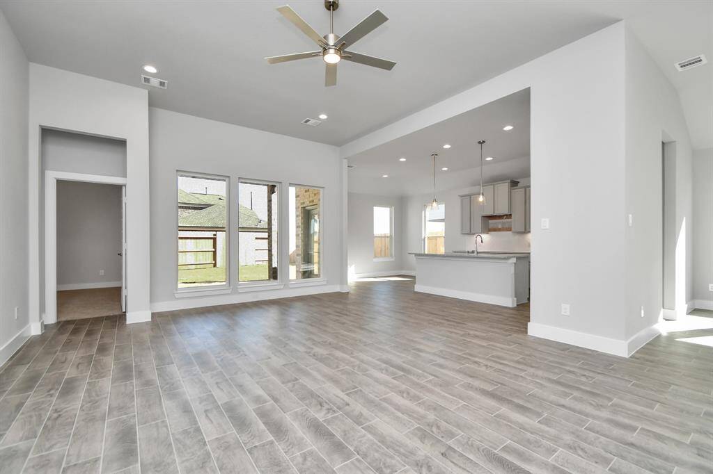 Take another glimpse into the heart of the home with this additional view of the family room—a sprawling space ready to accommodate all your gatherings. Sample photo of completed home with similar plan. As built color and selections will vary.
