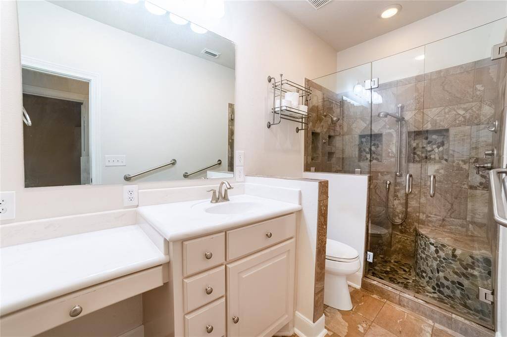 Guest bathroom has a beautiful walk in shower.