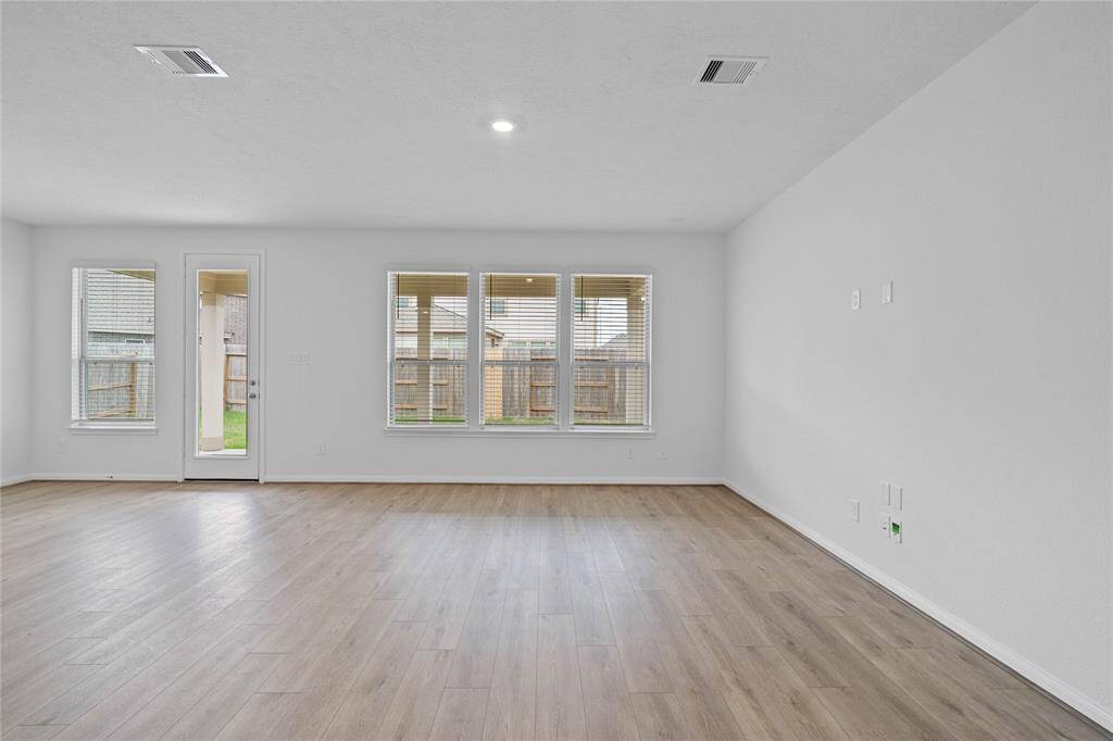 The open concept great room and kitchen makes for a impressive way to keep the party going and never miss a beat! The Great Room features large windows, 2" wood blinds, high ceilings, recessed lighting, and Layton Lake Vinyl Plank flooring!