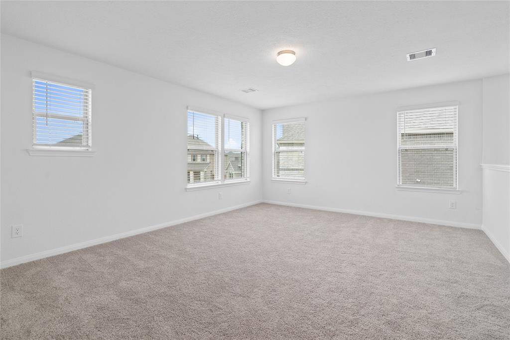 Perfect for entertaining is this amazing game room! Right upstairs this space would be a fabulous teen hangout, media room, or adult game room complete with enough room for a pool table and big screen TVs! Featuring plush carpet, high ceilings, custom paint, lighting, and large windows with faux wood blinds!