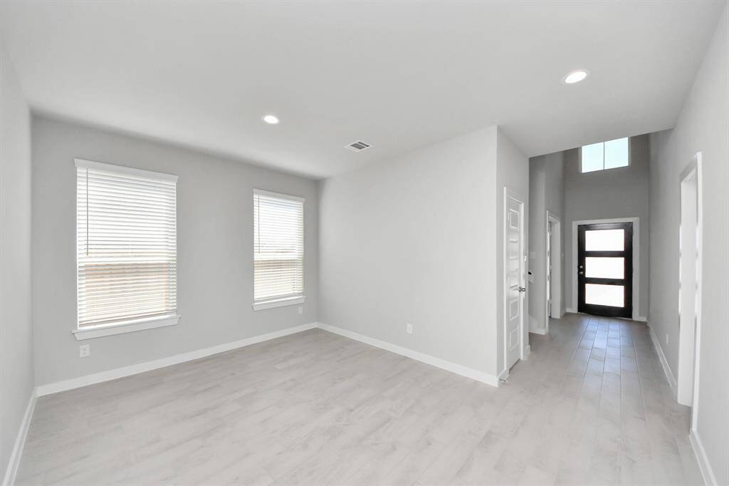 The kitchen is a culinary haven, featuring granite countertops, a tile backsplash, stainless steel appliances, 42” upper cabinets, and undercabinet lighting.