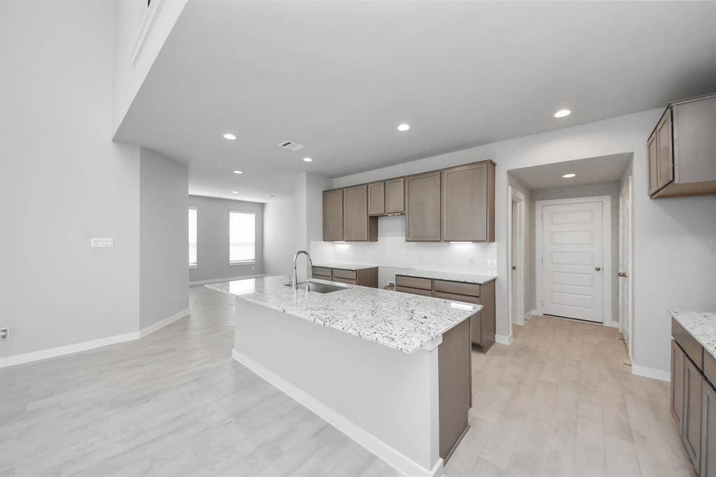 Family room flooded with natural light through the expansive windows.