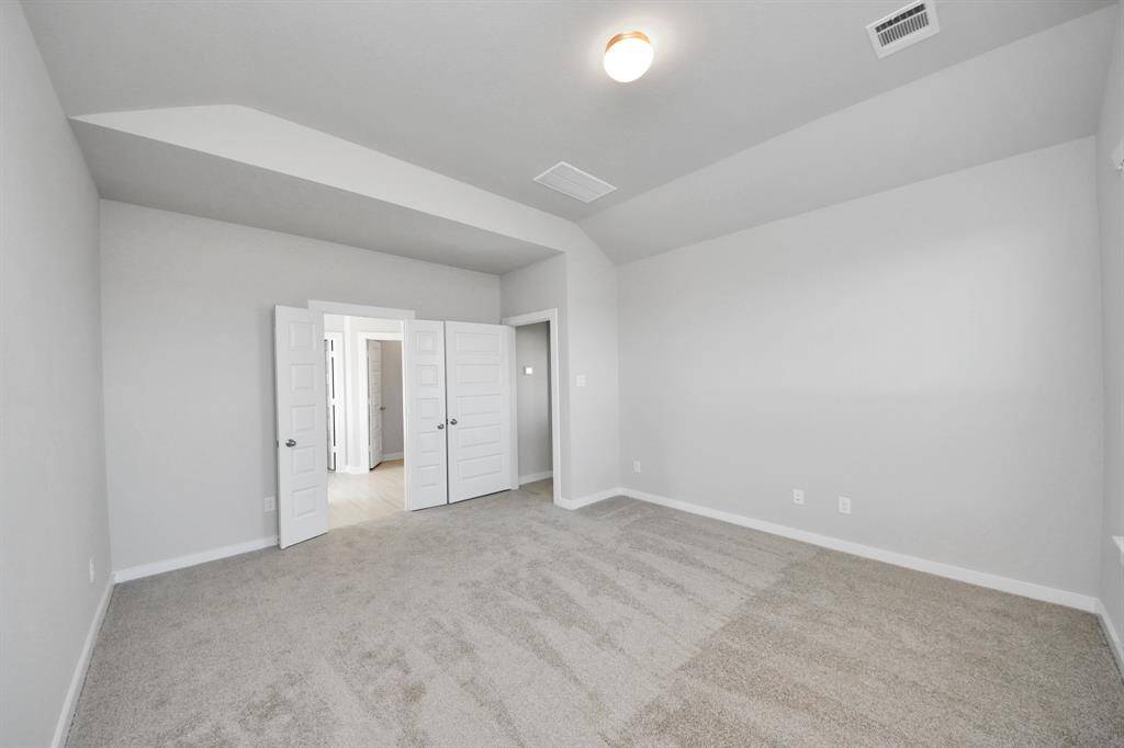 Walk-in closet that epitomizes luxury and practicality. This generously sized space features built-in shelving, offering abundant room for impeccable organization. High ceilings and recessed lighting create a bright and welcoming ambiance.
