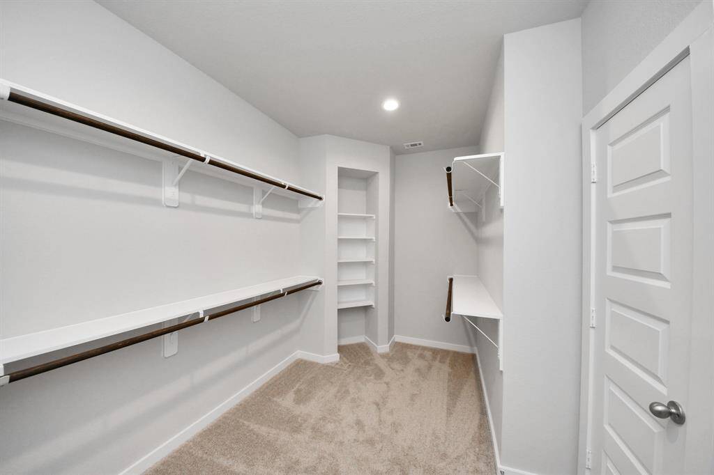 Elevate your daily routine at the elegant vanity, now equipped with double sinks, light countertops, modern hardware, and beautiful recessed lights.