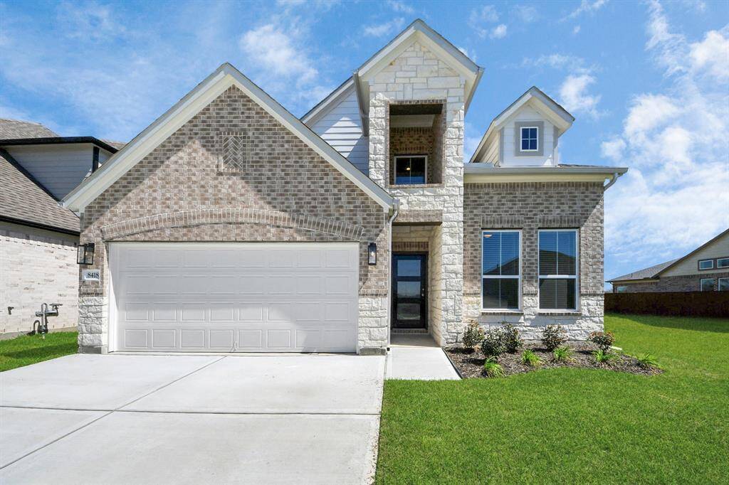 The residence features a practical 2-car garage complemented by a generous driveway, ensuring abundant space for parking needs.