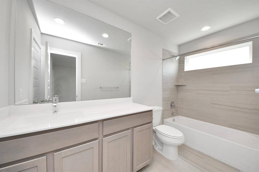 Secondary bedroom features plush carpeting, large windows that let in plenty of natural light, bright paint, and spacious closets.